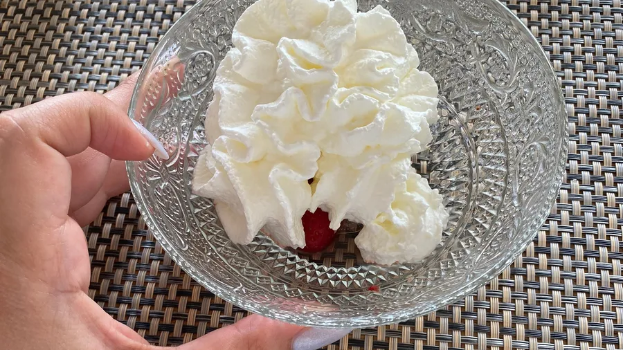 Mountain of whipped cream in a cut-glass bowl