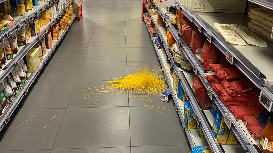 Burst of spilled spaghetti on a supermarket floor