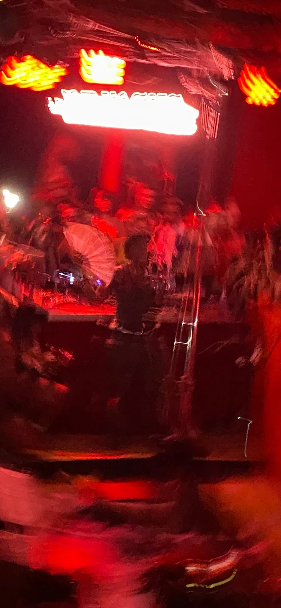 Club dissolving into red streaks and silhouettes