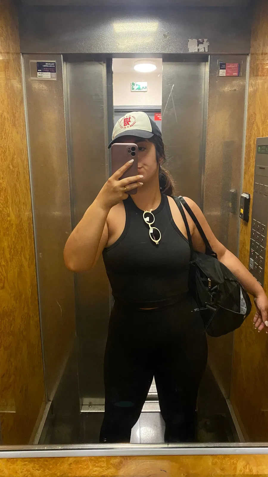 Lift mirror selfie in black, same cap