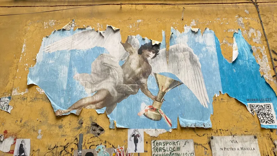Torn poster of a flying angel on a peeling yellow wall