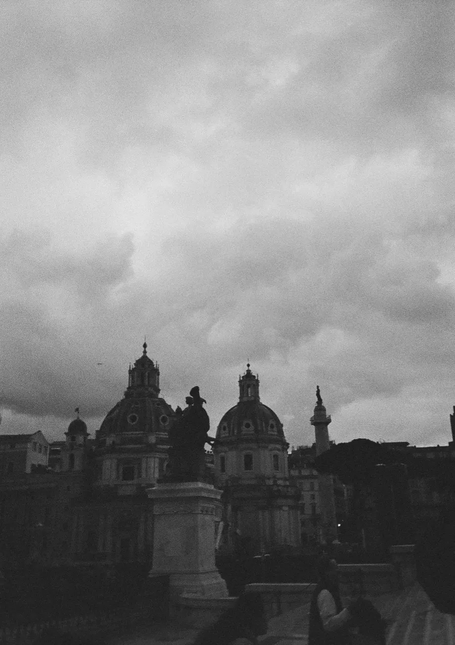Twin domes in silhouette under a brooding sky