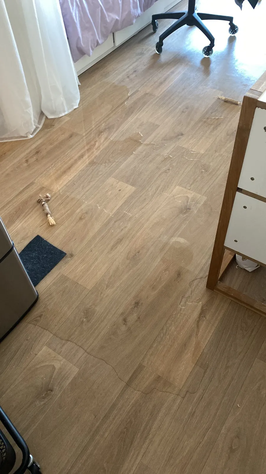 Empty wooden floor and a stray object, off-kilter room shot