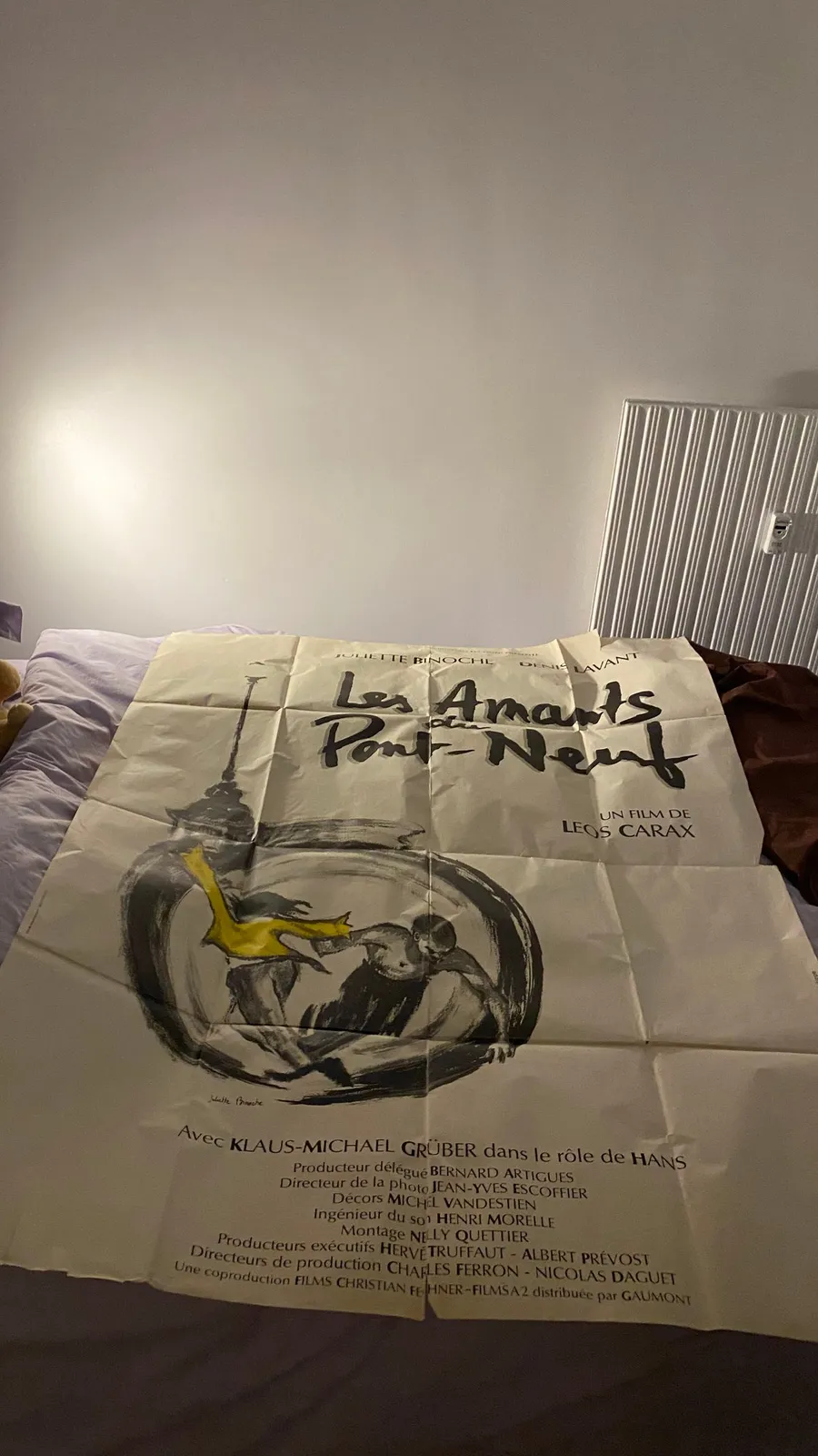 Les Amants du Pont-Neuf poster unrolled on a bed