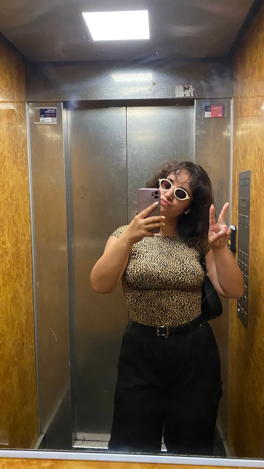 Lift mirror selfie, leopard top, peace sign, white sunglasses