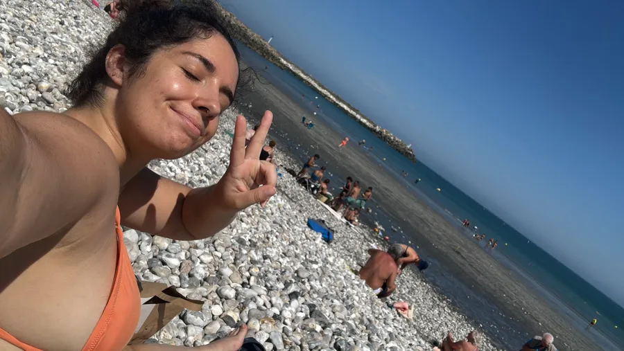 Tilted beach selfie, peace sign, the horizon sliding sideways