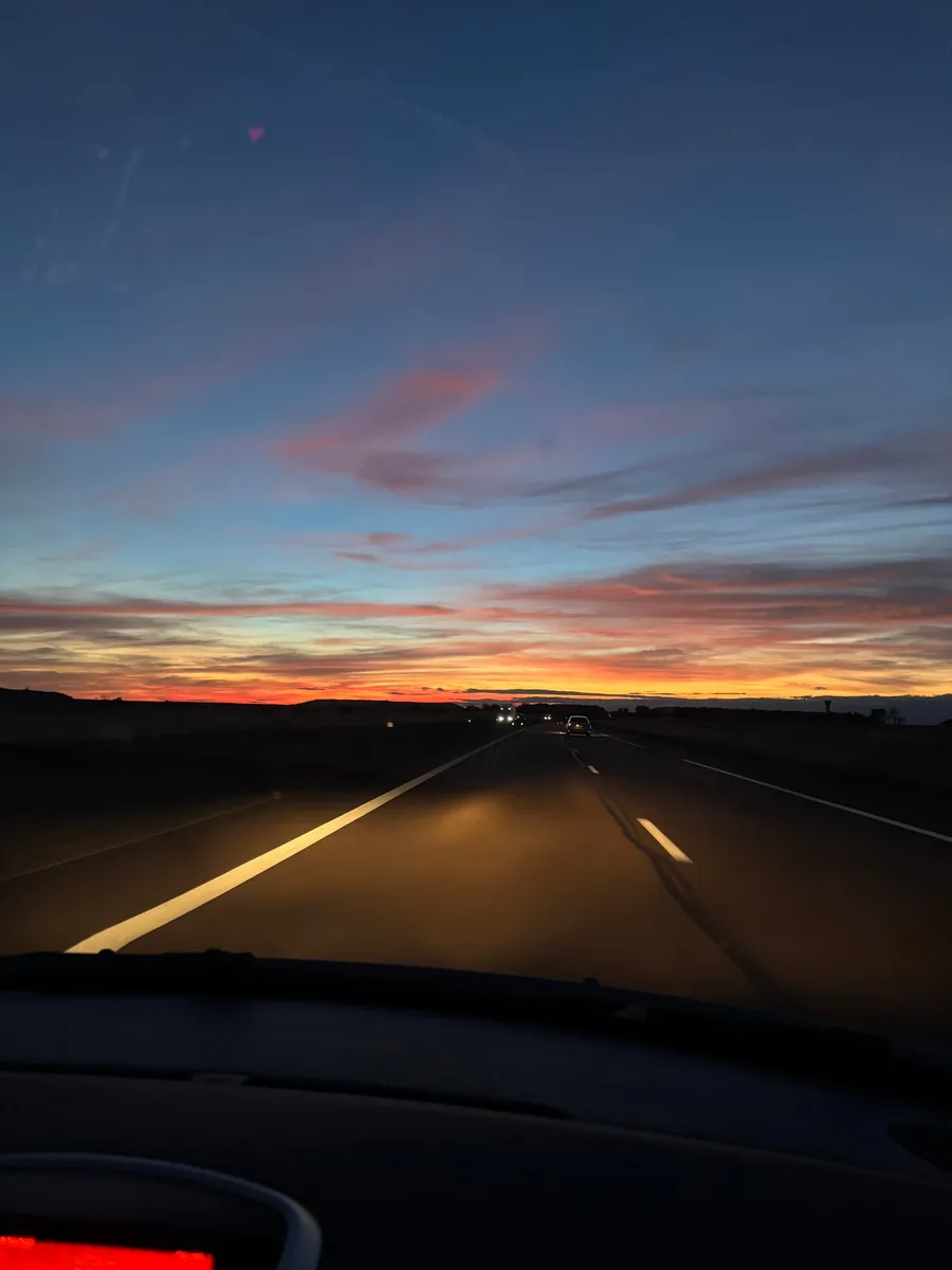 Dusk sky over an empty road from the car