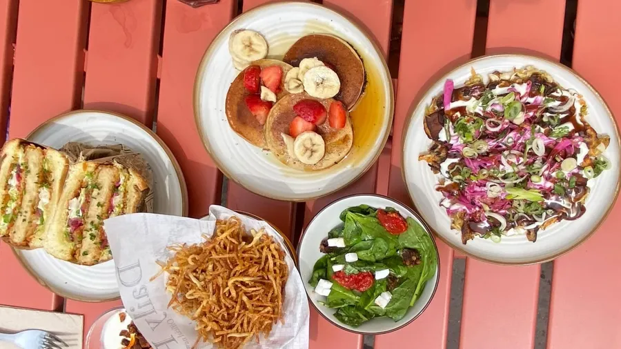 Brunch spread from above on a red slatted table
