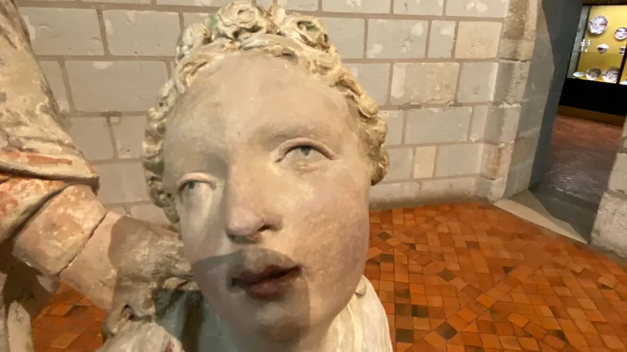Weathered stone face with parted lips, eerie and tender