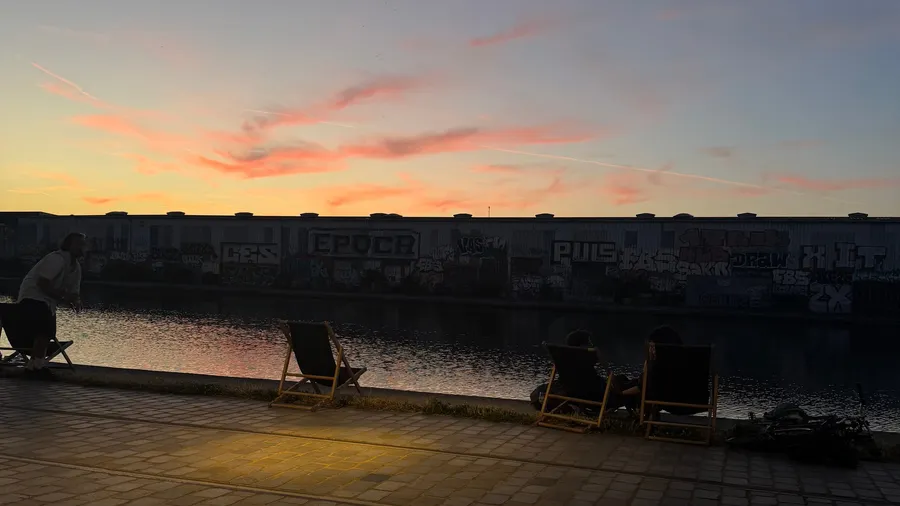 Pink streaked sky over the canal, deckchairs in silhouette