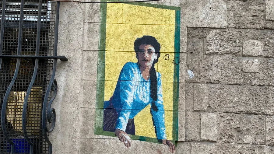 Mural of a woman leaning out of a painted window, Marseille
