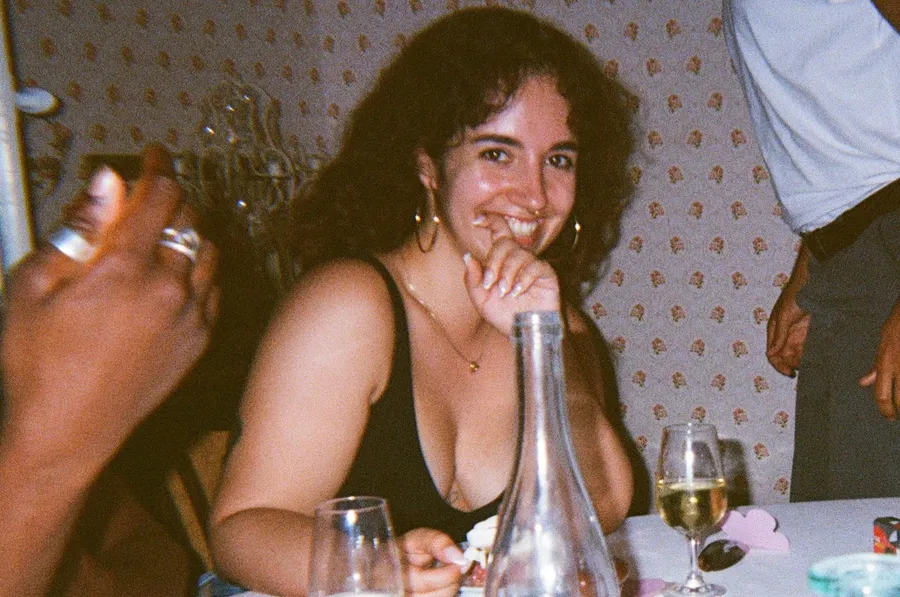 Laughing at a dinner table, flash, wine glasses, warm party mood