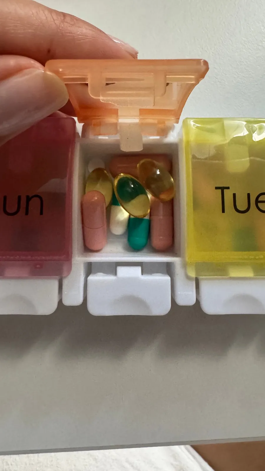 Weekly pill box, Mon/Tue lids, colourful capsules