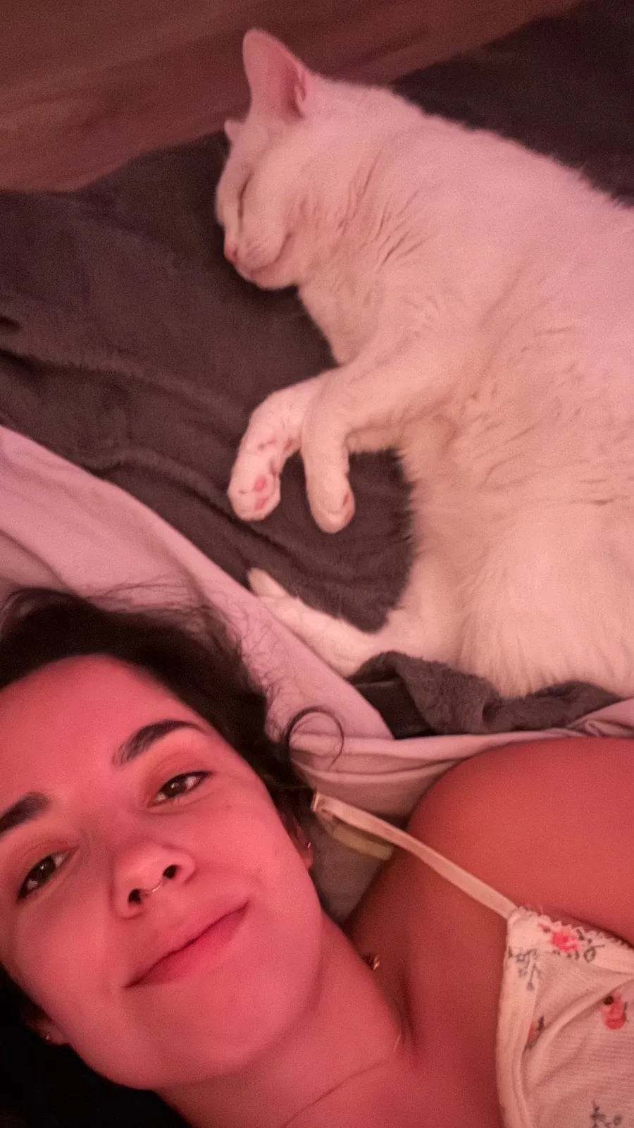 Sleepy selfie in bed, white cat curled up above my head