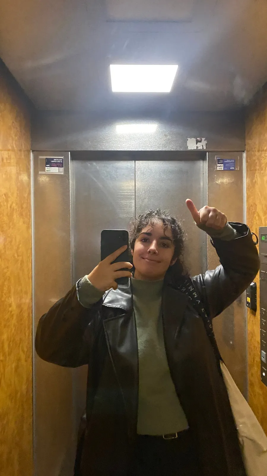 Lift mirror selfie, thumbs up, smiling