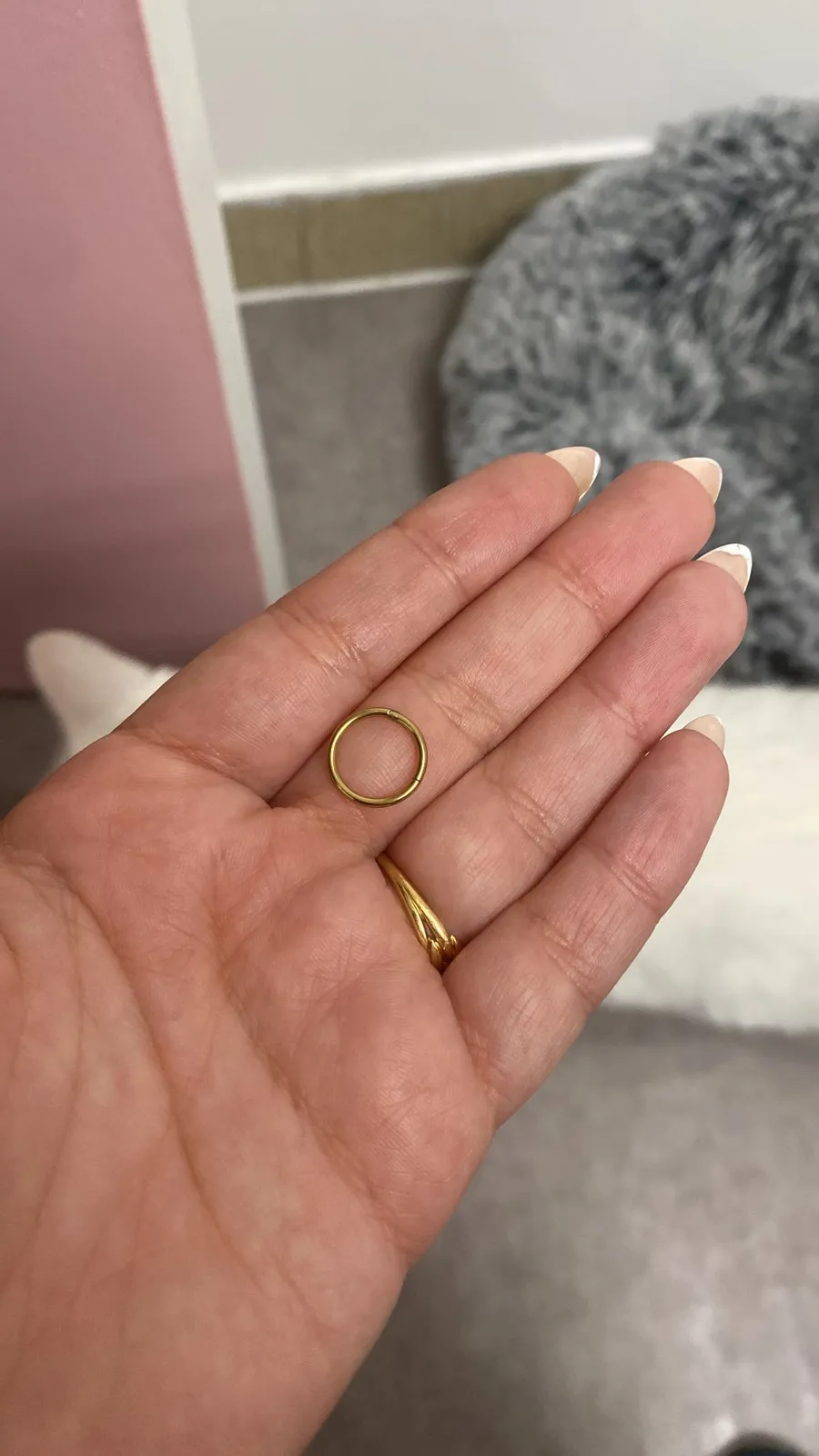 Open palm holding two small gold rings