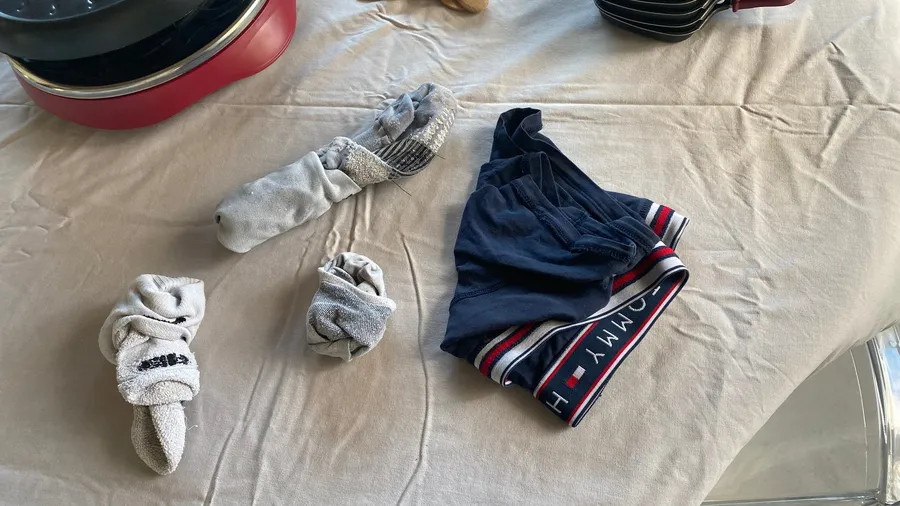 Socks and boxers abandoned on a tablecloth, quiet domestic comedy