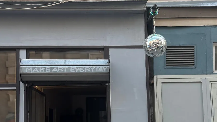 'Make art every day' shopfront with a disco ball