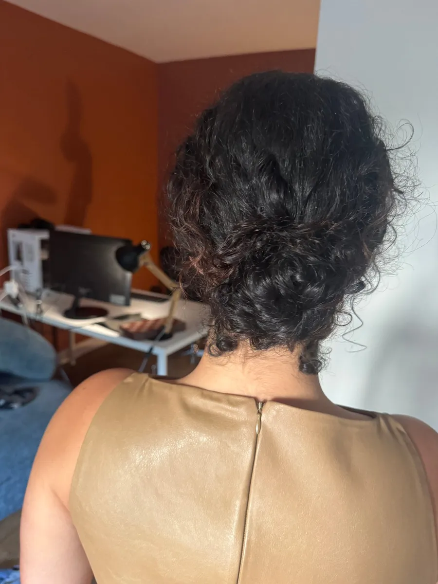 Back of a curly bun and leather top