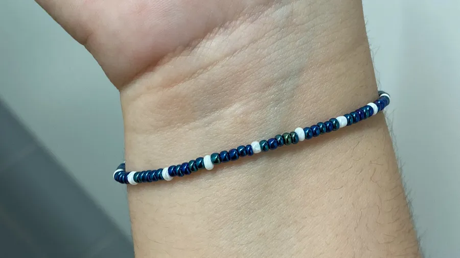 Navy and white beaded bracelet on a pale wrist